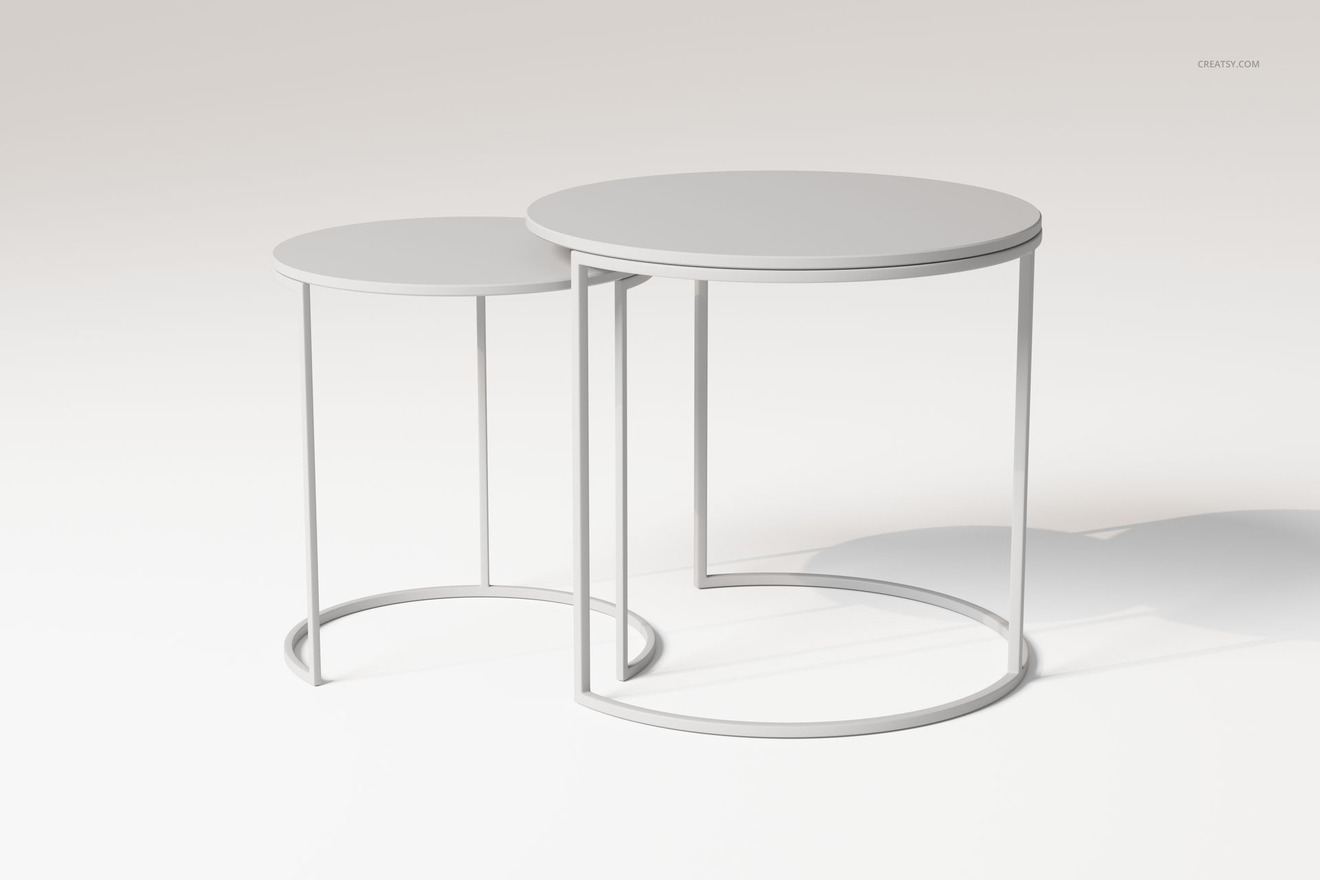 Nesting coffee table set with two round tables in white, shown from a front angle on a plain background.