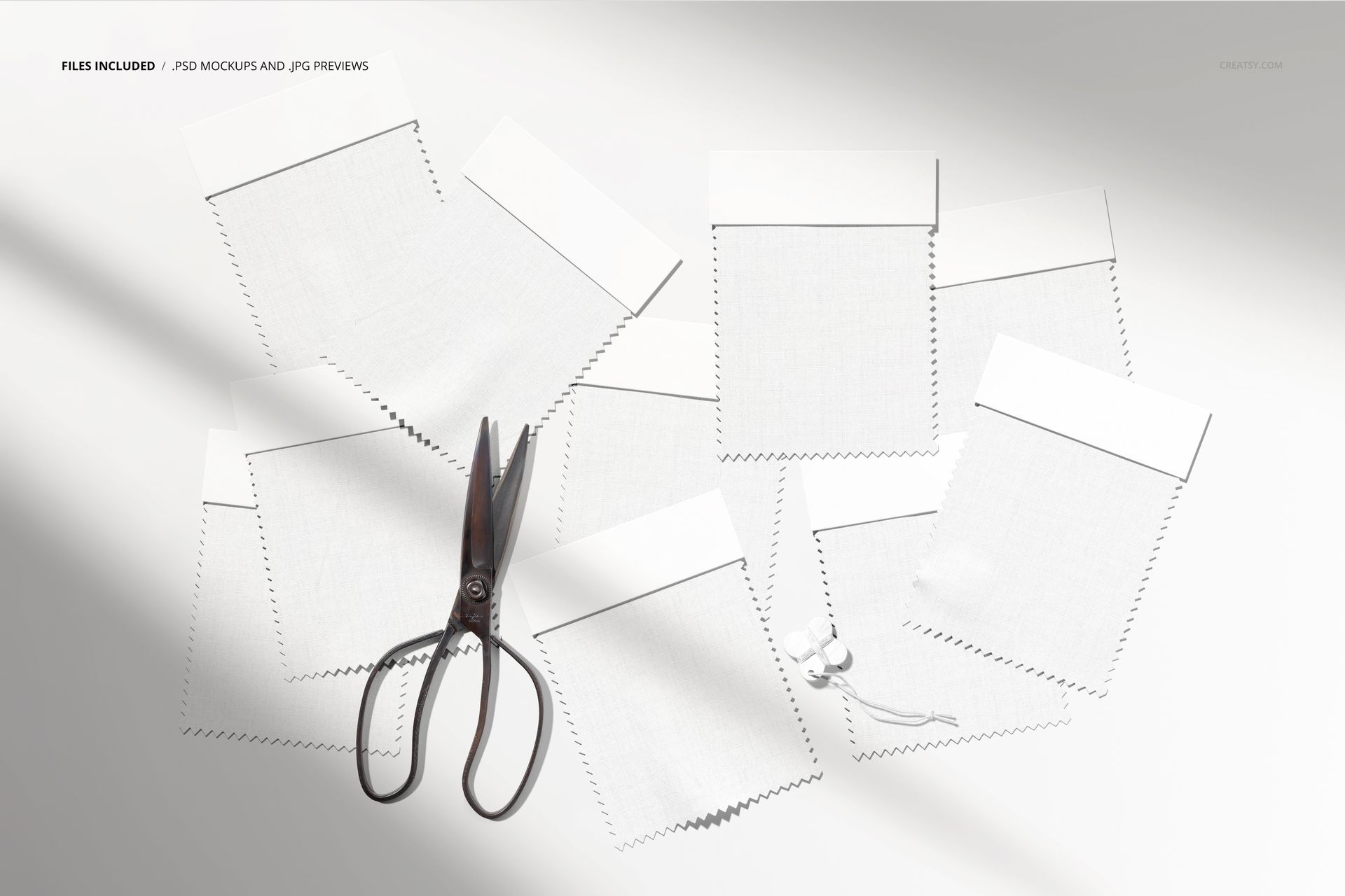 Fabric swatches mockup featuring several textured white samples, scissors, and string, shown from an overhead perspective.