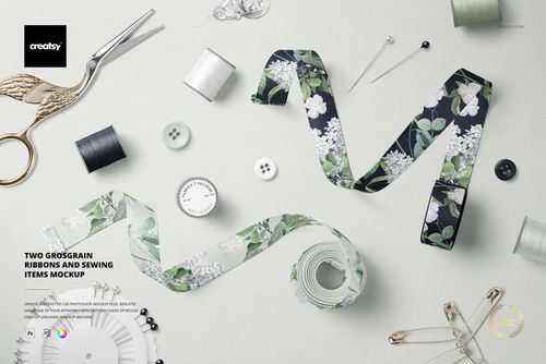 PSD mockup showing two floral grosgrain ribbons with sewing accessories such as scissors, pins, and safety pins arranged nearby.