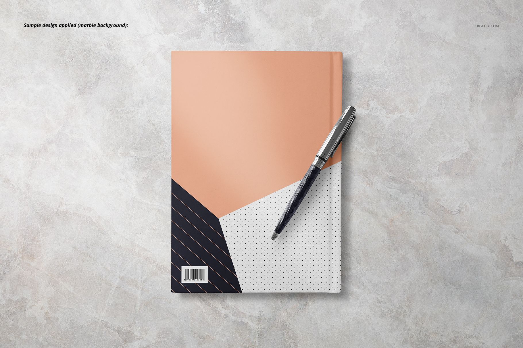 Notebook mockup featuring a modern geometric cover in peach, black, and white, shown from above on a stone background.
