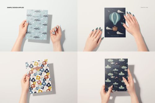 Four greeting cards mockup featuring women’s hands holding cards with various colorful designs, viewed from above.