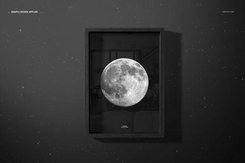 Vertical wooden picture frame mockup with a black border, featuring a grayscale moon design on a dark wall.