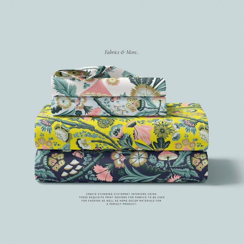 Folded bedding set mockup showing three stacked fabric pieces with colorful floral patterns on a light blue background.