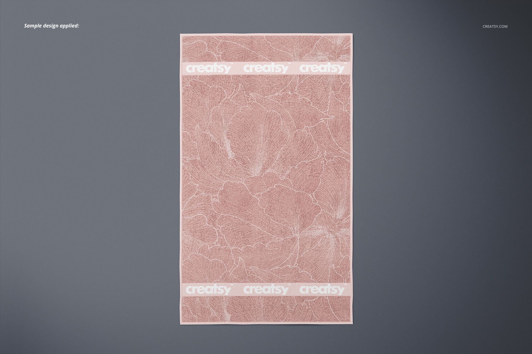 Top view of a pink bath towel mockup with subtle marble texture and two white horizontal stripes on gray surface.