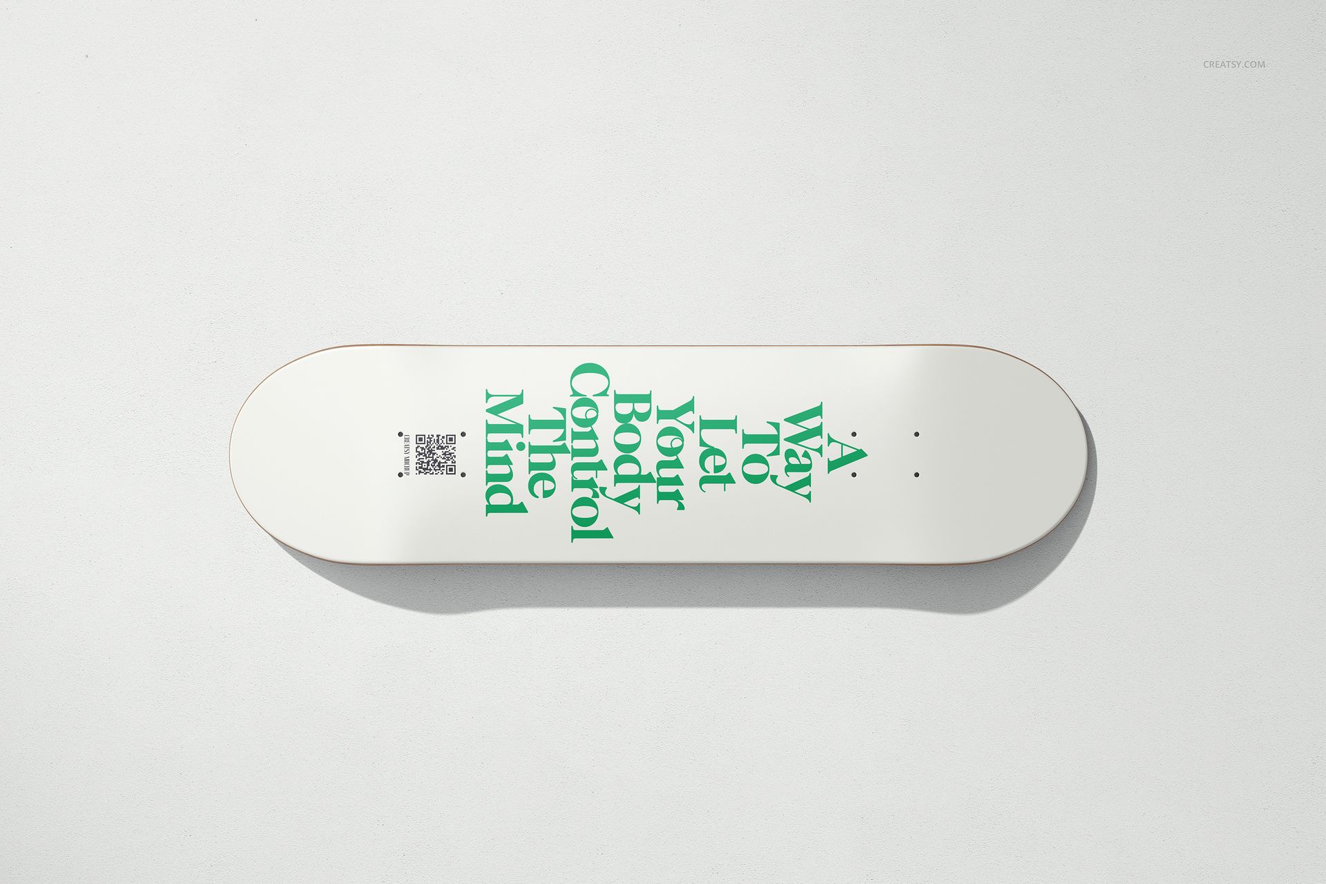 Top view of a skateboard deck mockup featuring bold green typography on a clean white surface.