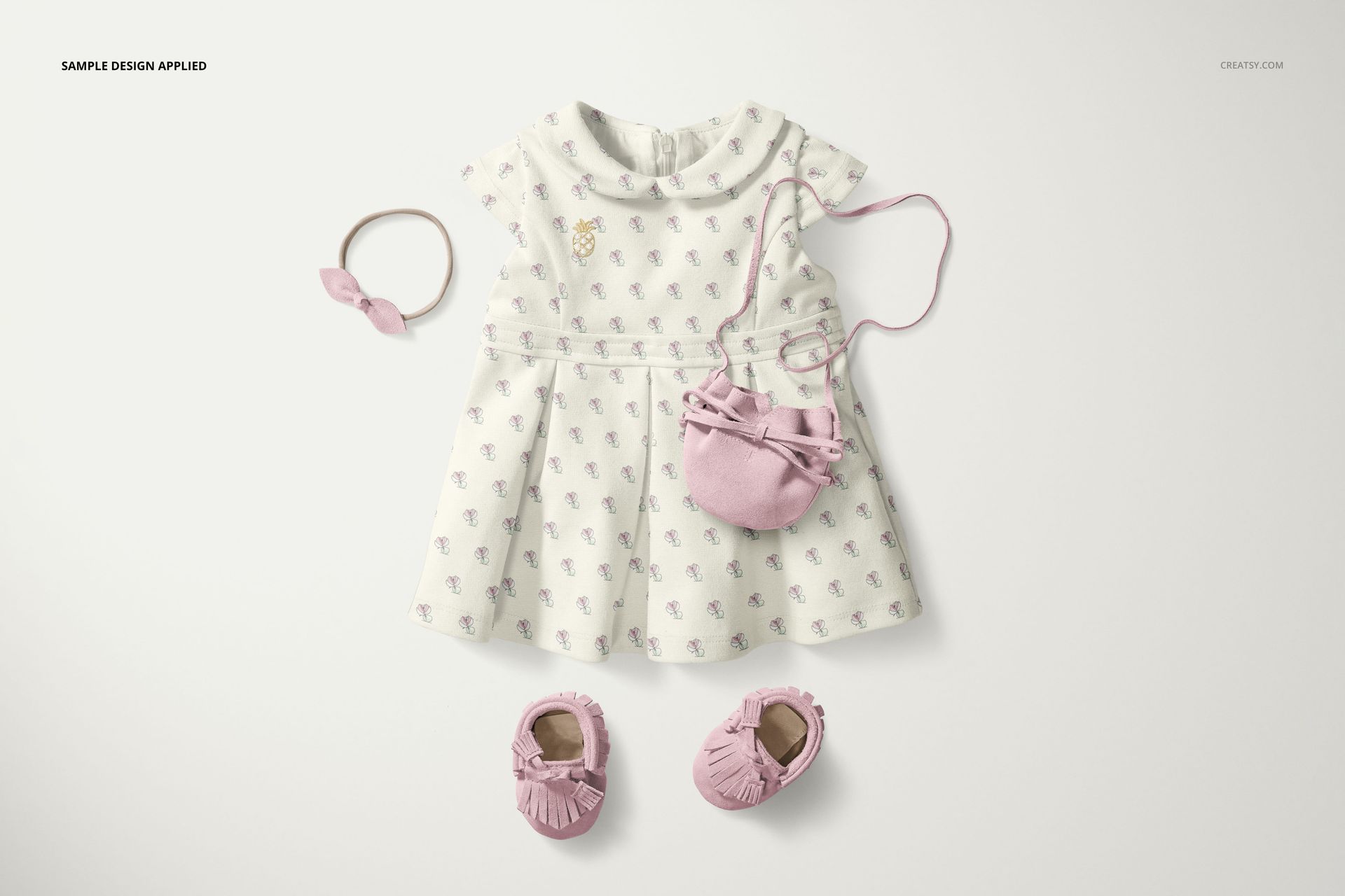 Peter Pan collar baby dress mockup set shown from above, accompanied by pink moccasins, headband, and purse.