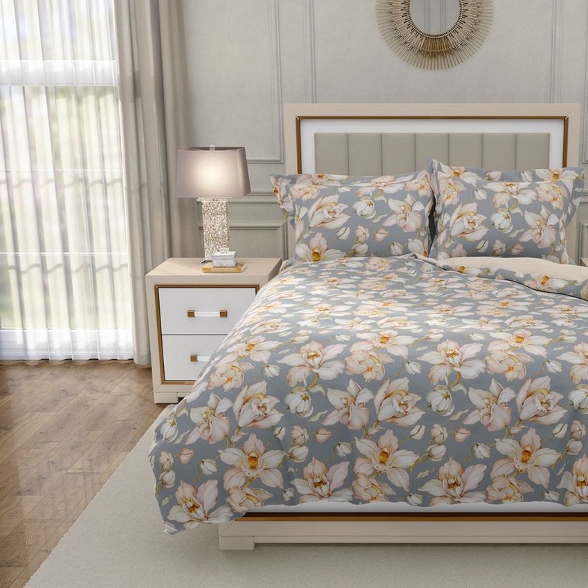 Luxury bedroom bedding mockup featuring a bed with floral-patterned duvet and pillows in a softly lit, elegant room.