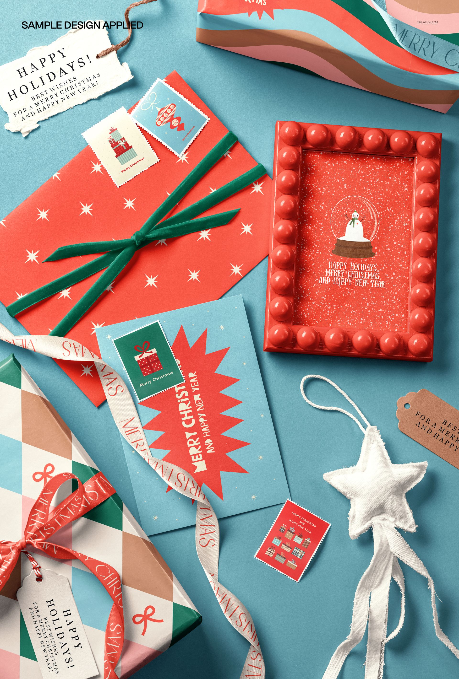 Assorted holiday-themed stationery, gift tags, and wrapped presents arranged on a blue surface in a PSD mockup scene.