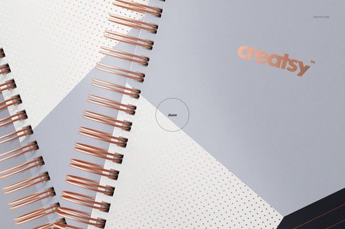 PSD mockup featuring wire-bound stationery planners with rose gold spirals, gray and white covers, and subtle dot accents.