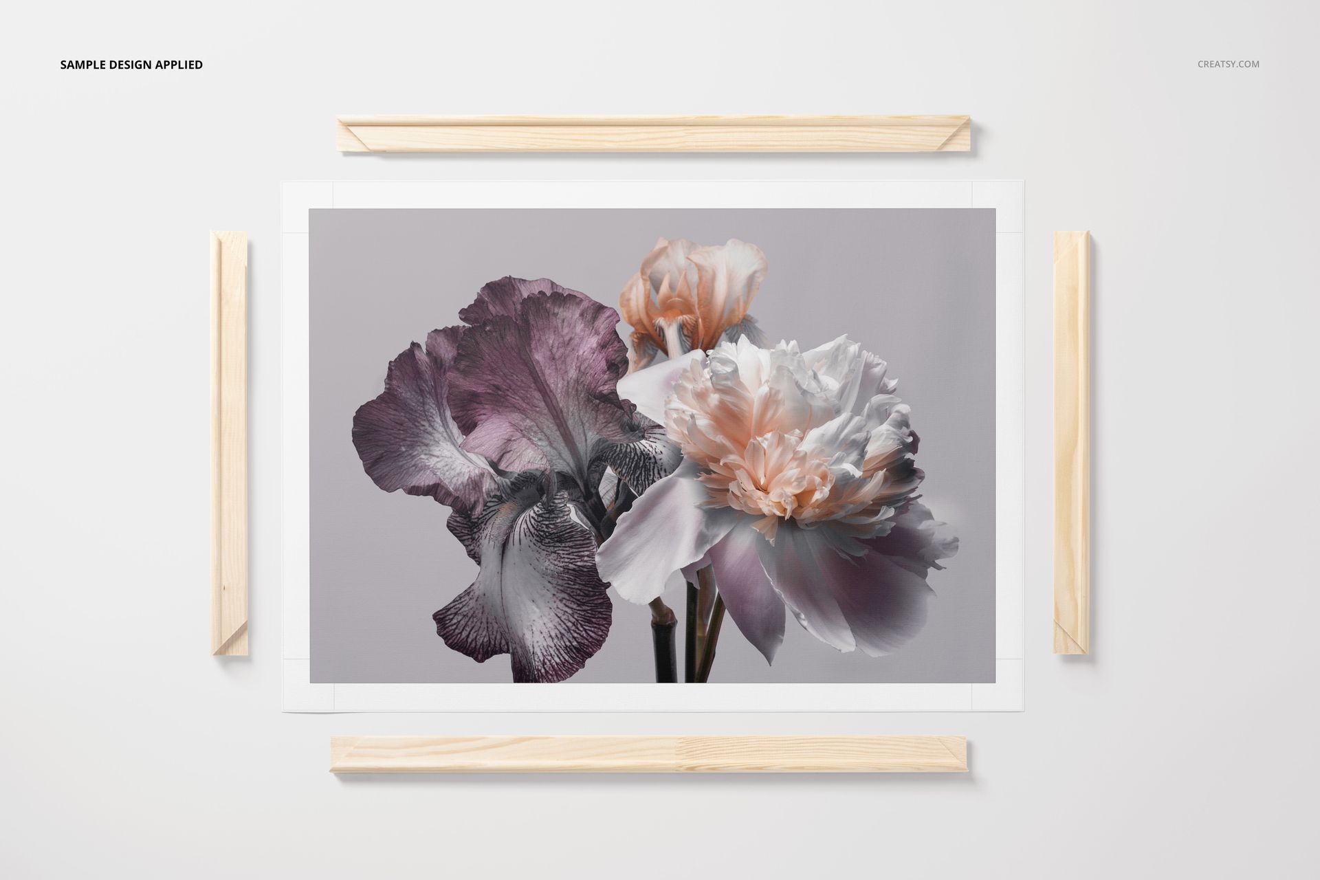Rolled canvas print mockup featuring a floral design with purple and peach flowers, displayed with wooden frame pieces.