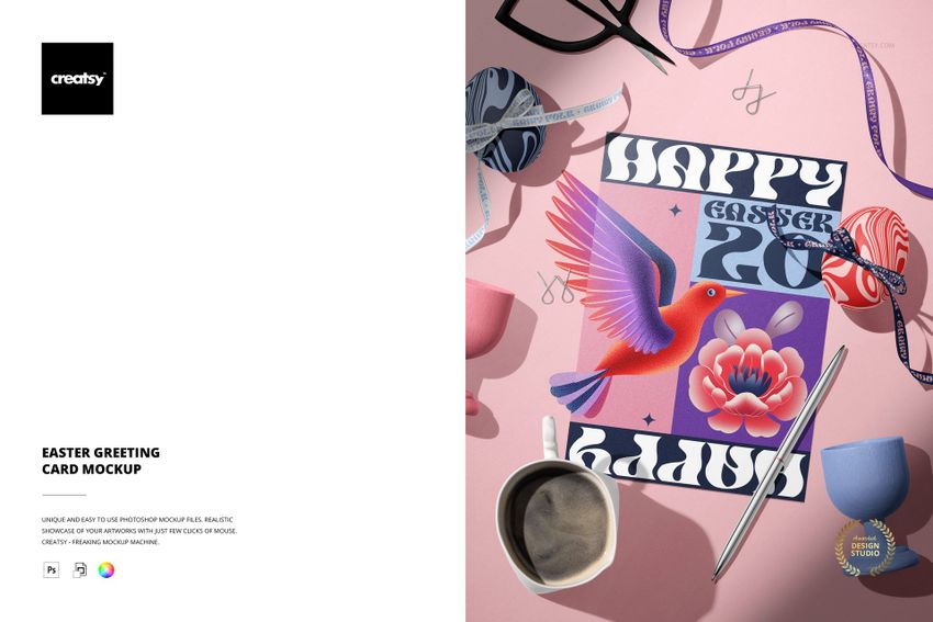 Top view of an Easter greeting card mockup on a pink table with colorful eggs, ribbons, scissors, and a coffee mug.