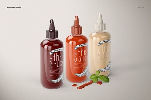 PSD mockup showing three sauce bottles with editable labels, front view, accompanied by basil and sauce drips on the surface.