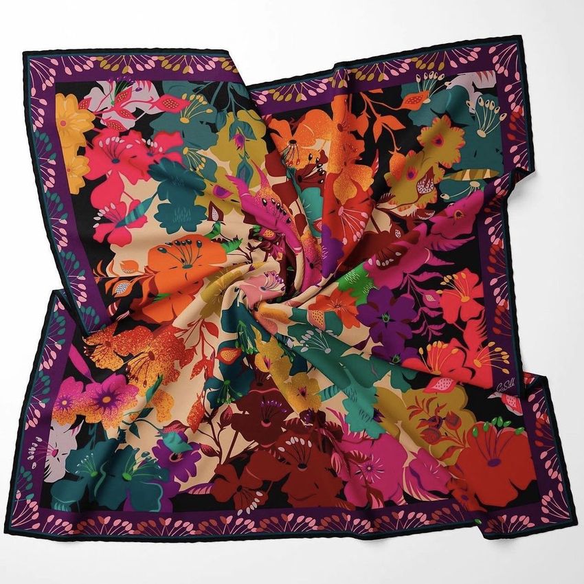 Twill silk scarf mockup featuring a vibrant floral pattern in red, orange, green, and purple tones on a white background.