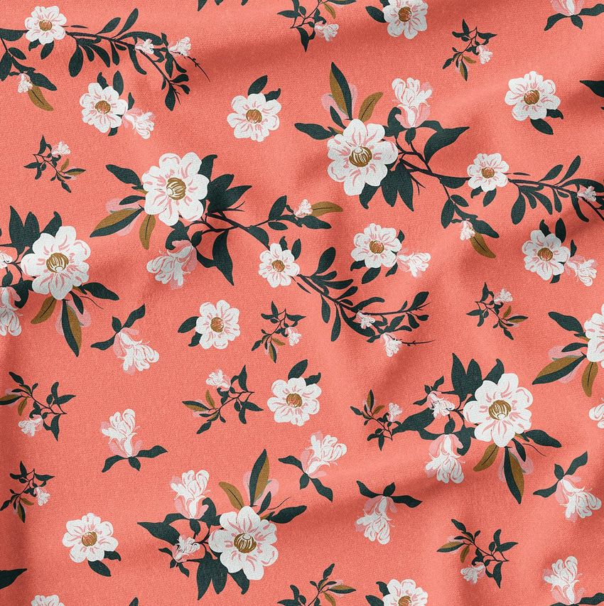 Creased fabric mockup featuring a coral background with a repeating pattern of white flowers and green leaves.