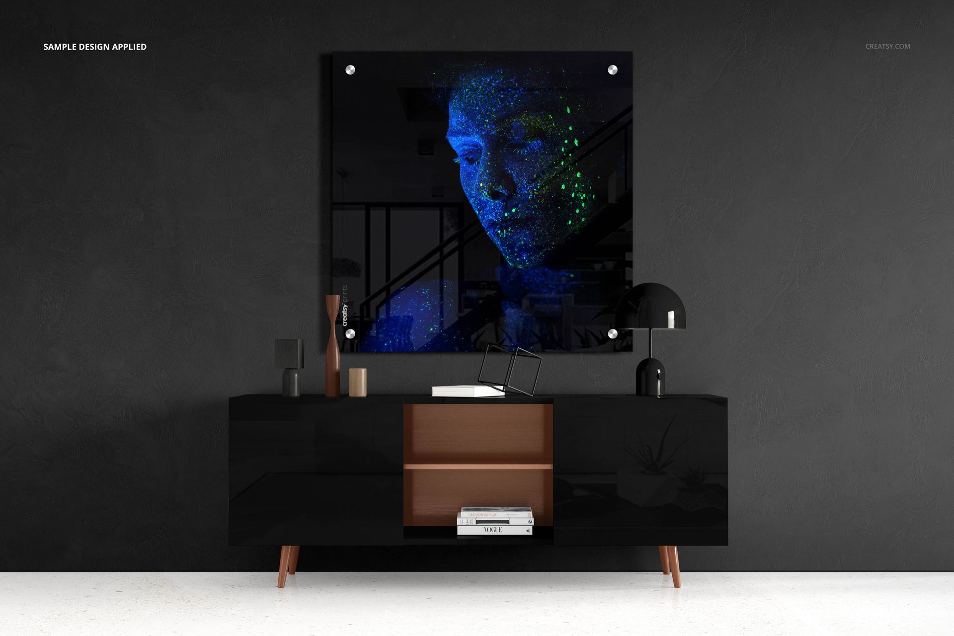 Rectangular acrylic print mockup displayed above a modern black sideboard against a dark textured wall.
