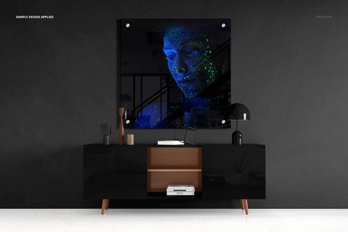 Rectangular acrylic print mockup displayed above a modern black sideboard against a dark textured wall.
