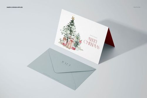 Folded 5x7 greeting card mockup with Christmas tree and presents design, shown next to a gray envelope on a light surface.