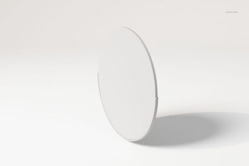 Round wall mirror with a minimalist frame, shown from a side angle on a plain light background with soft shadows.