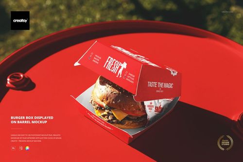 Open burger box mockup featuring a red and white package on a red barrel, viewed from a slightly elevated angle.