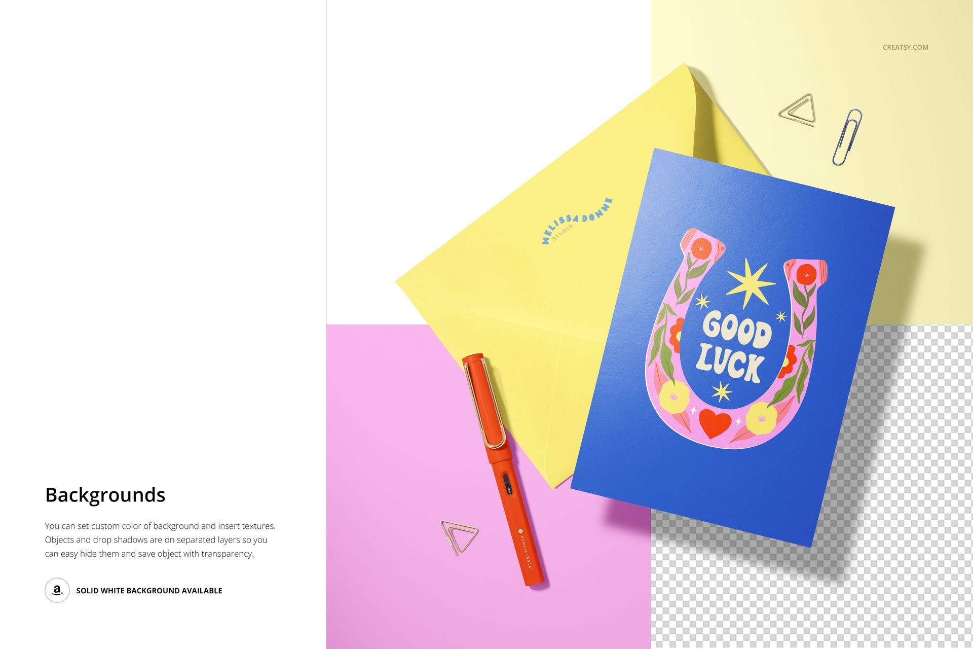 A5 card mockup featuring a blue card with vibrant artwork, yellow envelope, orange pen, and gold paper clips on a desk.
