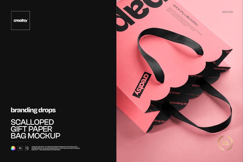 Scalloped gift paper bag with black handles, shown in a front angled view on a pink background, PSD mockup format.