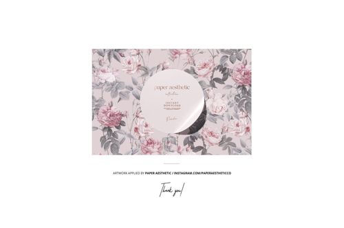 Mockup of a rectangular pillow with piping detail, displayed on a surface with a pink and gray floral design.