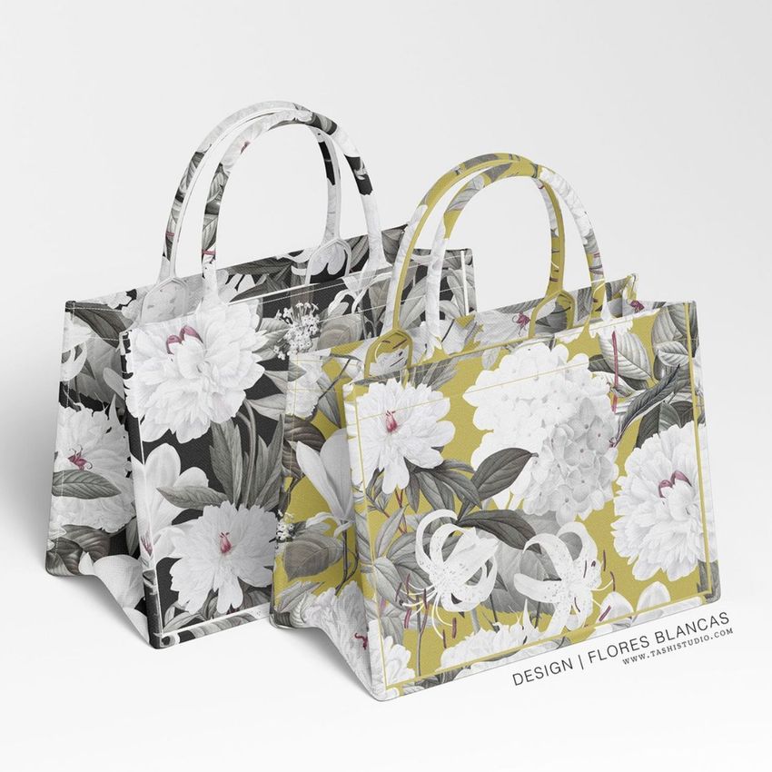 Canvas tote bag mockup showing two bags with floral patterns, one in black and white and one in yellow and white, on a light background.