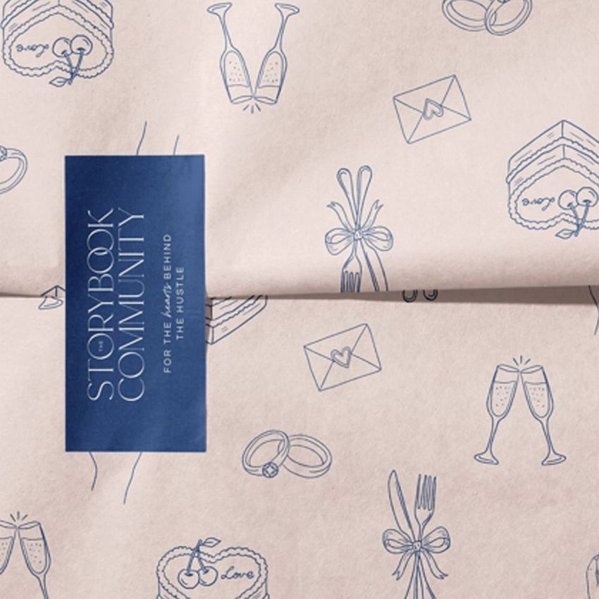 Wrapping paper mockup featuring hand-drawn blue illustrations of cake, champagne glasses, and envelopes on a light background.