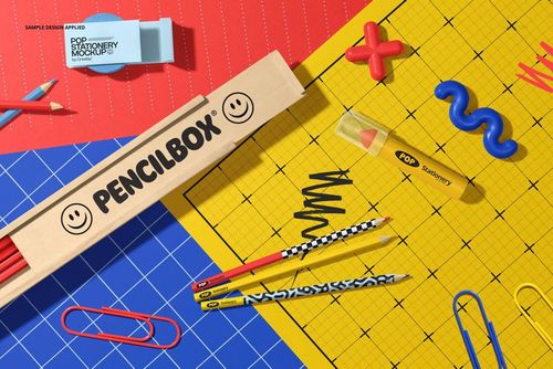 Stationery mockup showing a wooden pencil box, assorted pencils, and vibrant paper sheets with geometric patterns.