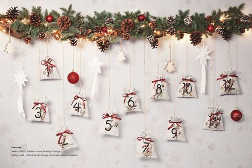 Front view of drawstring sacks advent calendar mockup hanging from a decorated pine garland with Christmas ornaments.