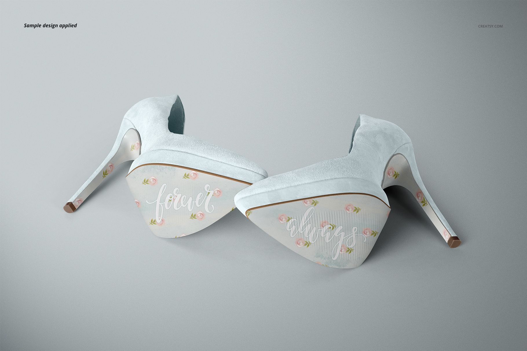 High heels mockup featuring two shoes with pastel blue suede and decorative soles, displayed on a neutral surface.