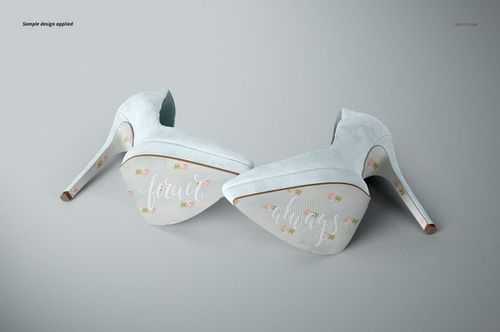 High heels mockup featuring two shoes with pastel blue suede and decorative soles, displayed on a neutral surface.