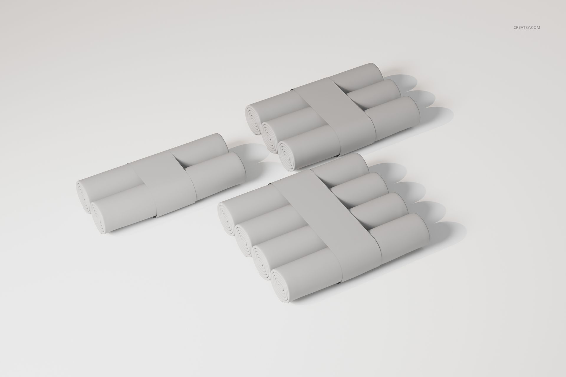 Three sets of changing pad paper rolls in a neutral color, arranged on a plain white surface with soft shadows.