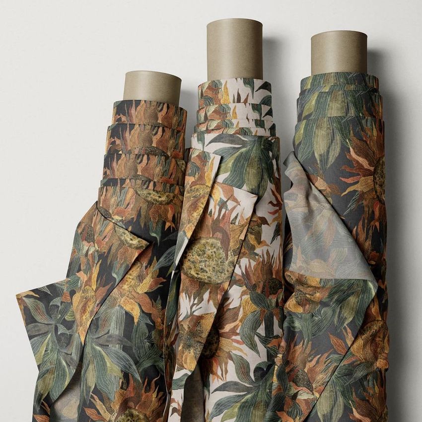Three fabric rolls mockup featuring sunflower patterns in earthy tones, displayed upright against a neutral background.