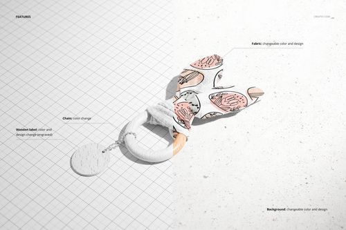PSD mockup of a wooden baby teether with patterned bunny ears, displayed on a grid and concrete background.