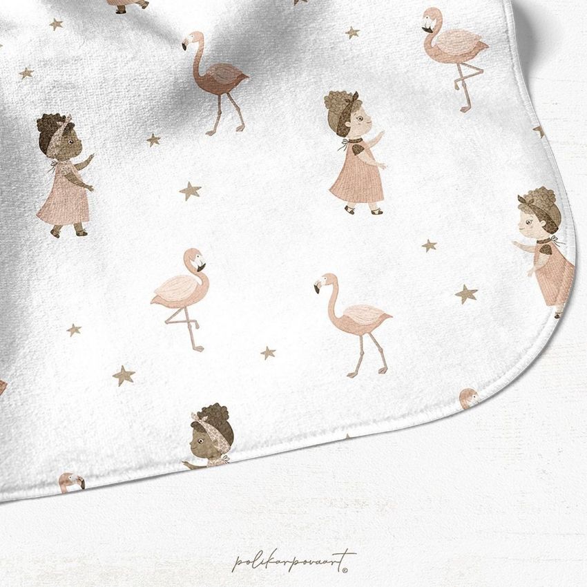 Hooded baby towel mockup featuring a white fabric with a repeating pattern of flamingos, stars, and girls in dresses.