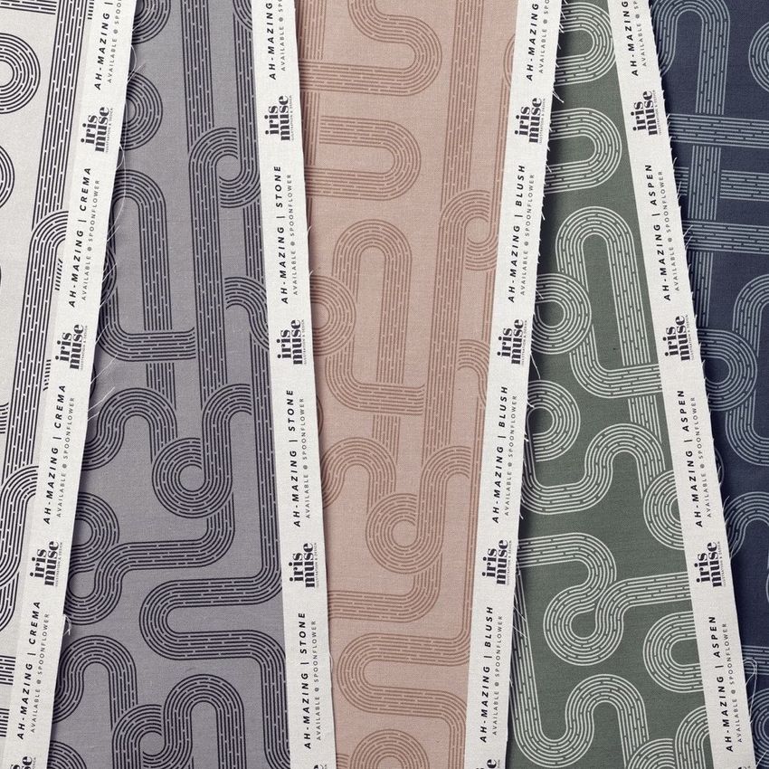 Cotton fabric sample mockup showing five fabric swatches with geometric line patterns in muted gray, beige, green, and blue tones.