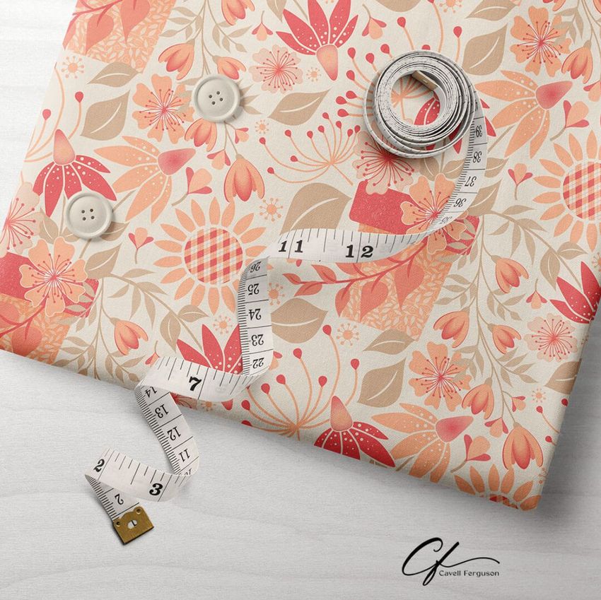 Folded fabric mockup featuring a peach and coral floral pattern, with a measuring tape and buttons on a light surface.