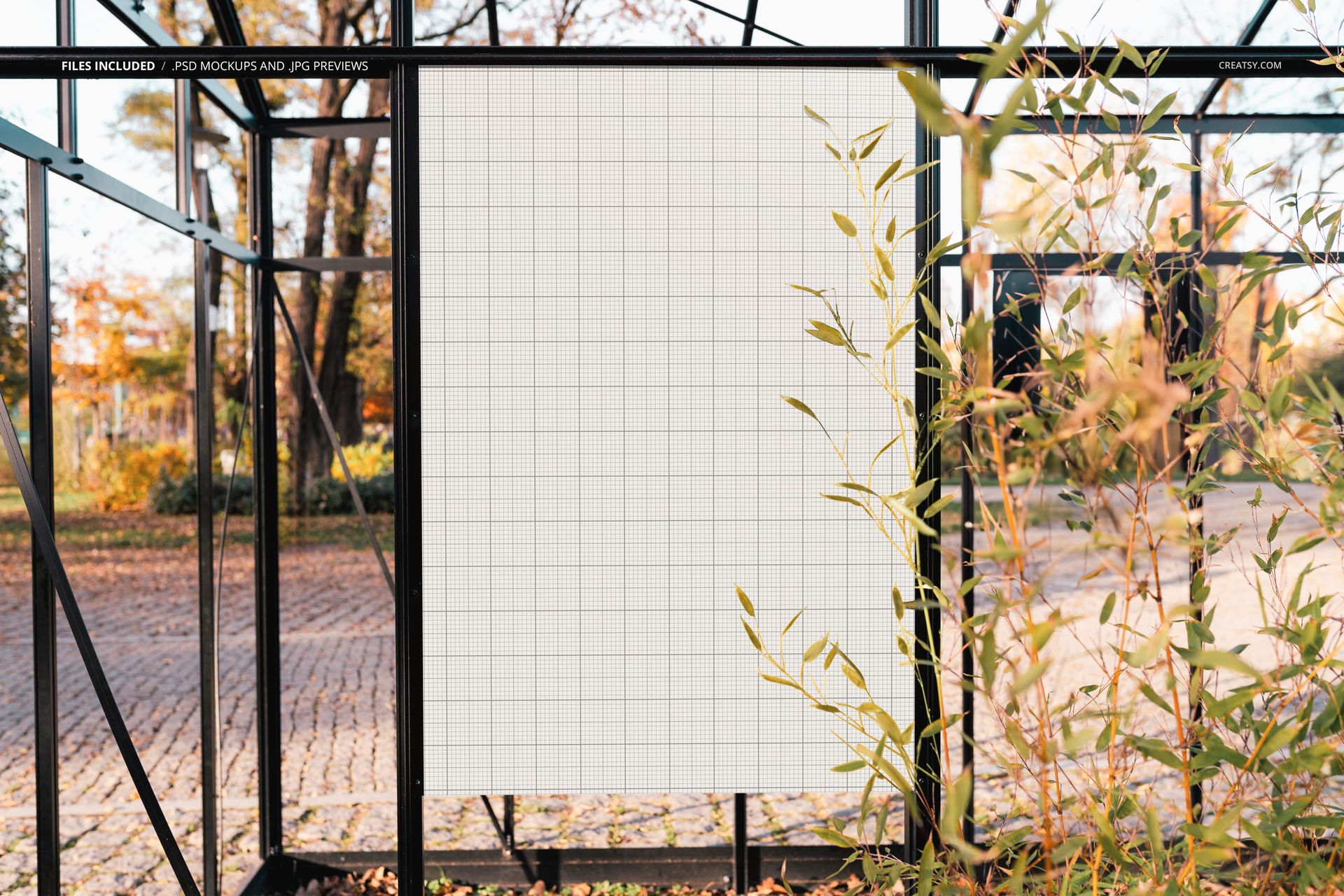 Large rectangular poster mockup with a grid pattern displayed outdoors in a park with autumn foliage and metal frame.