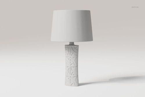 Front view of a decorative table lamp with a textured geometric base and plain white lampshade on a light background.