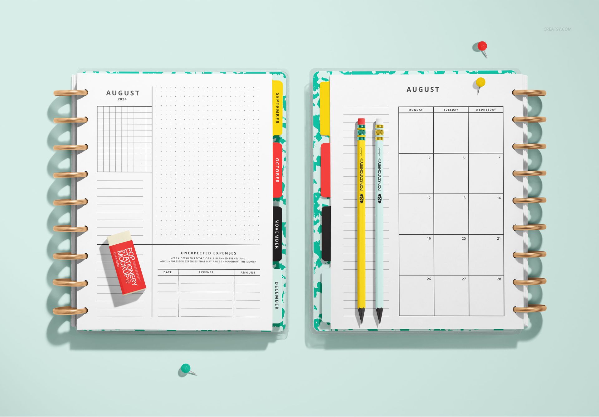 Mockup of a spiral planner with dividers, displaying calendar and notes pages alongside stationery items.