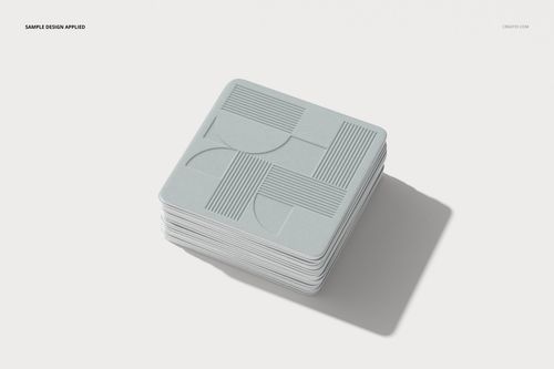 PSD mockup of square coasters with light gray geometric artwork, displayed on a clean, white surface.