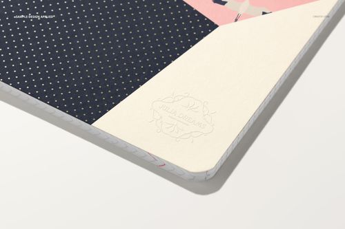 A5 notebook mockup with a navy blue cover featuring gold dots, cream corner accent, and embossed Julia Dreams logo.