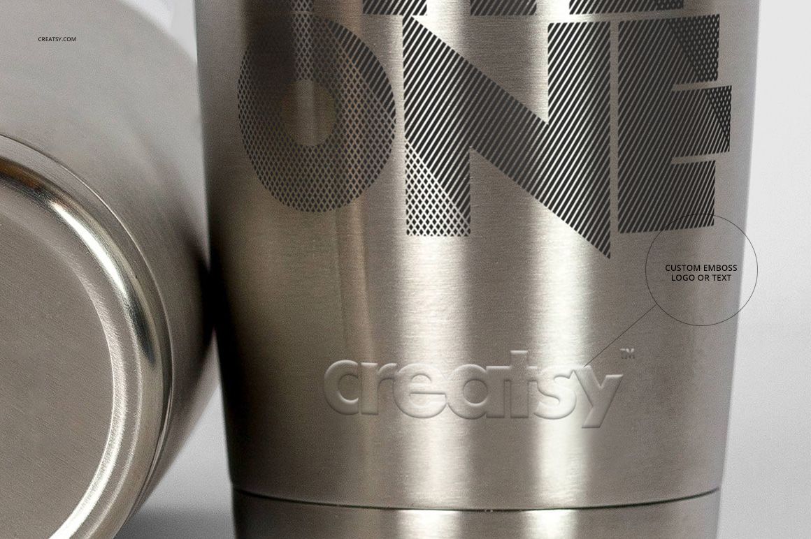 Front view of two stainless steel tumblers, one upright and one lying down, with engraved and printed text designs.