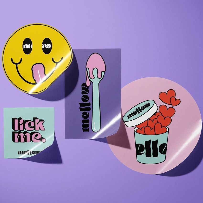 Sticker mockup featuring four colorful stickers with playful designs and bold text, arranged on a purple background.