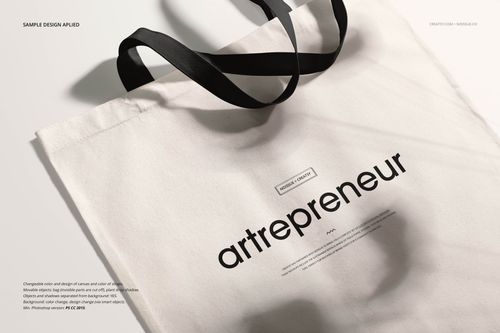 Mockup of a white tote bag with black straps and minimalist text design, displayed on a neutral background.