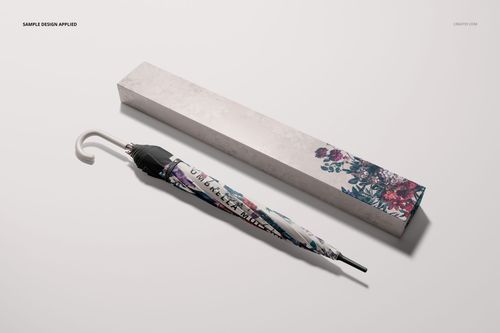 PSD mockup featuring a fashion accessory umbrella with colorful flower motifs and a matching packaging box in a minimal scene.