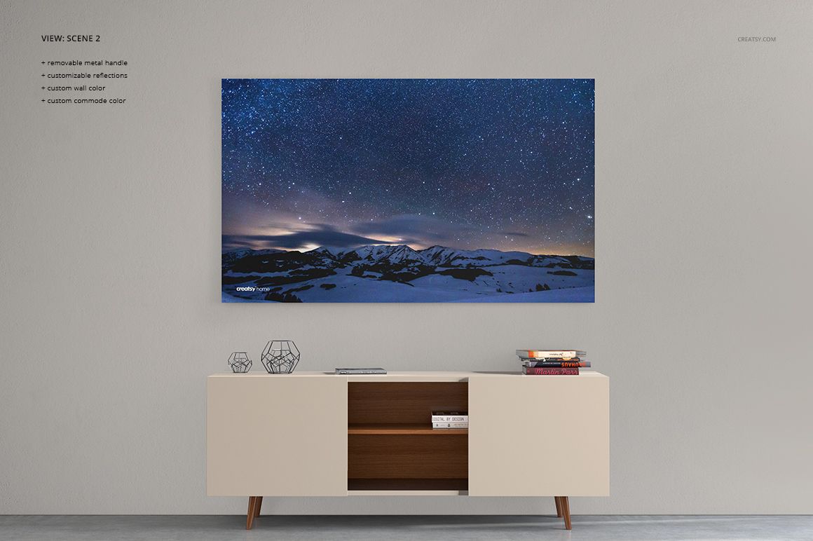Rectangular canvas print mockup with a starry night sky and mountain scene, mounted above a modern beige commode.