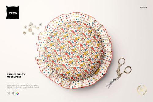 PSD mockup of a decorative round pillow with ruffled edges, patterned in red, yellow, and blue, surrounded by crafting items.