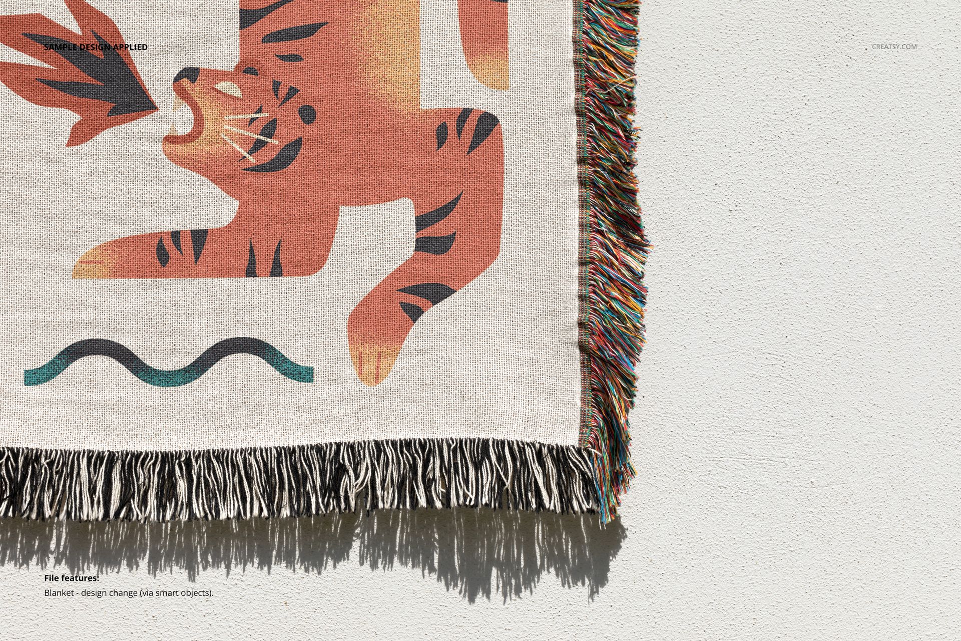 Jacquard throw blanket mockup featuring a bold tiger graphic and decorative fringes, displayed from a top view.